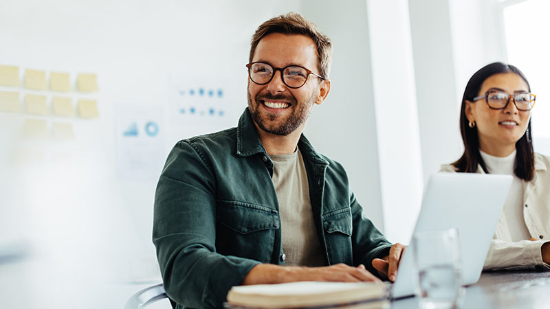 business man on laptop smiling